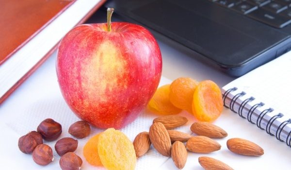 apple and nuts show the benefits of snacking for health